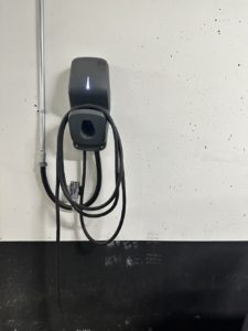 A Flo Home G5 EV Charger installed on the wall of a parking space